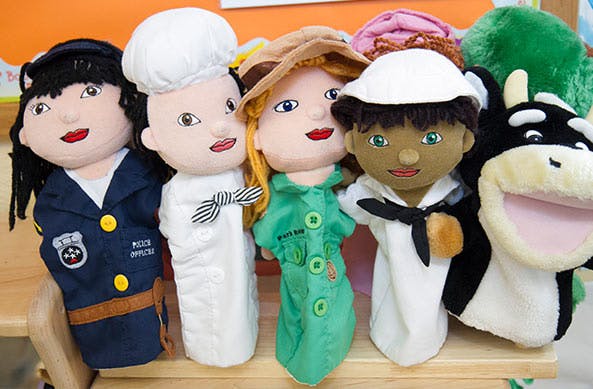 Five hand puppets, including a police officer, chef, and sailor