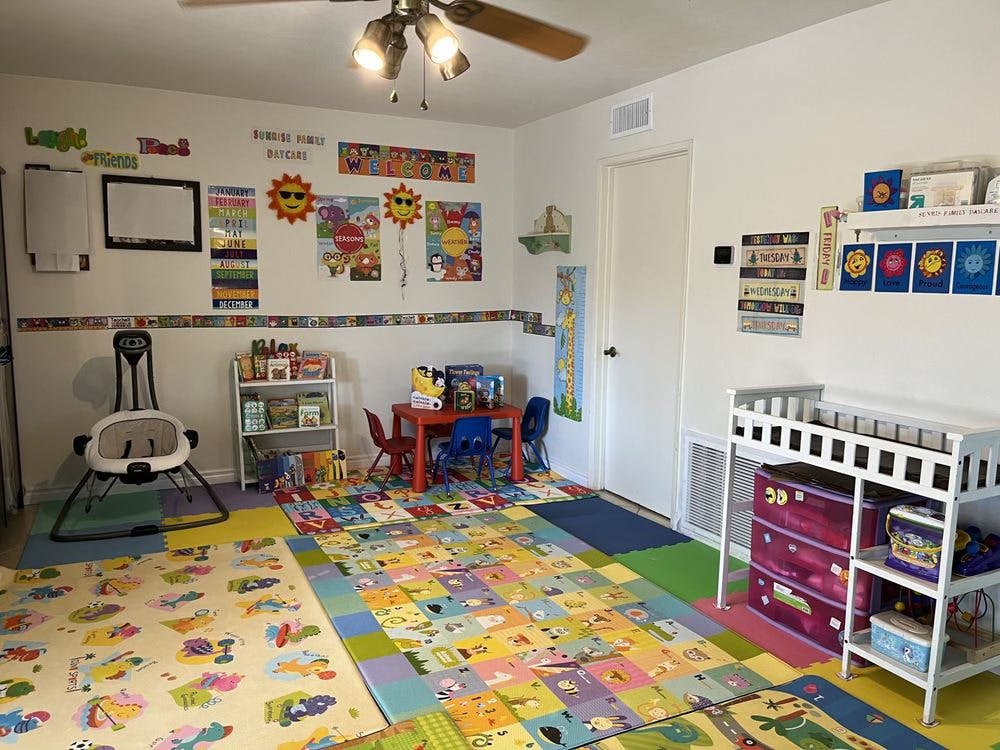 Child's playroom with colorful floor mats, small table, and changing station