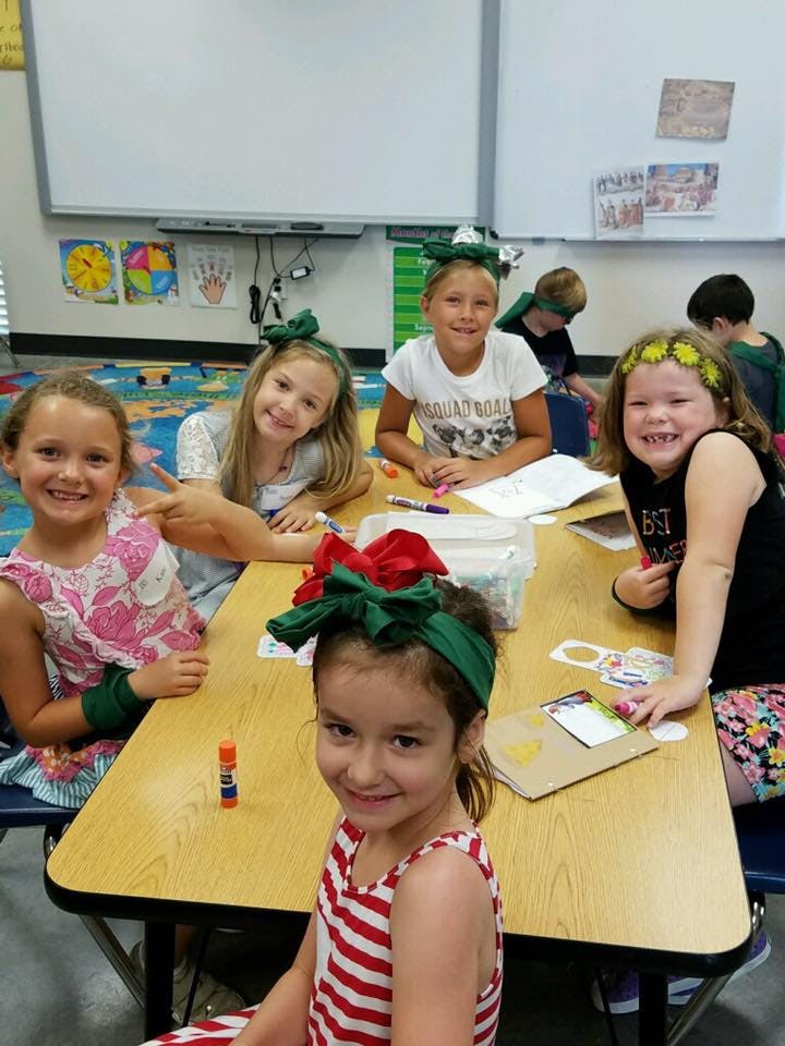 Children sitting at a table in a classroom