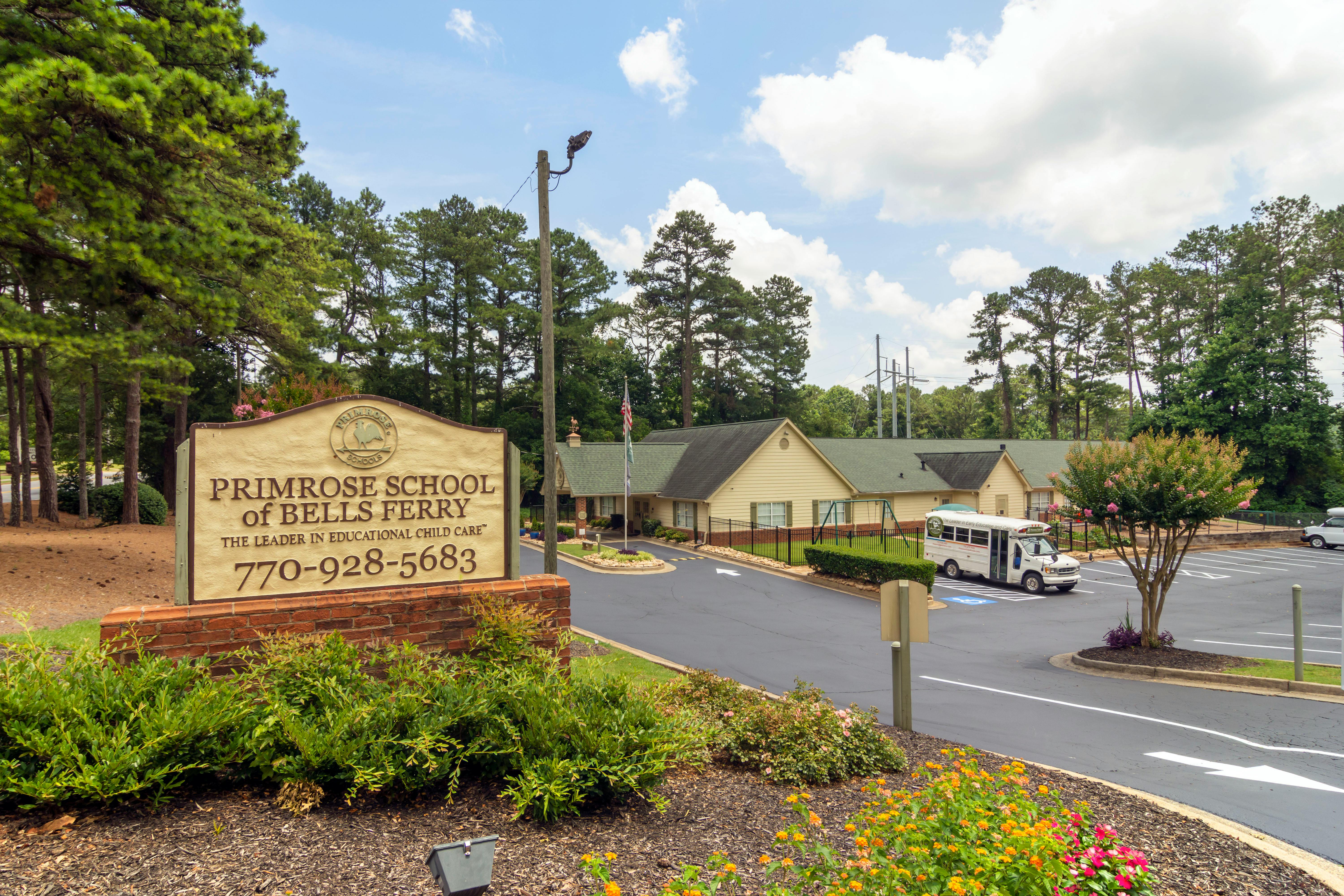 Sign for Primrose School of Bells Ferry in front of building and parking lot