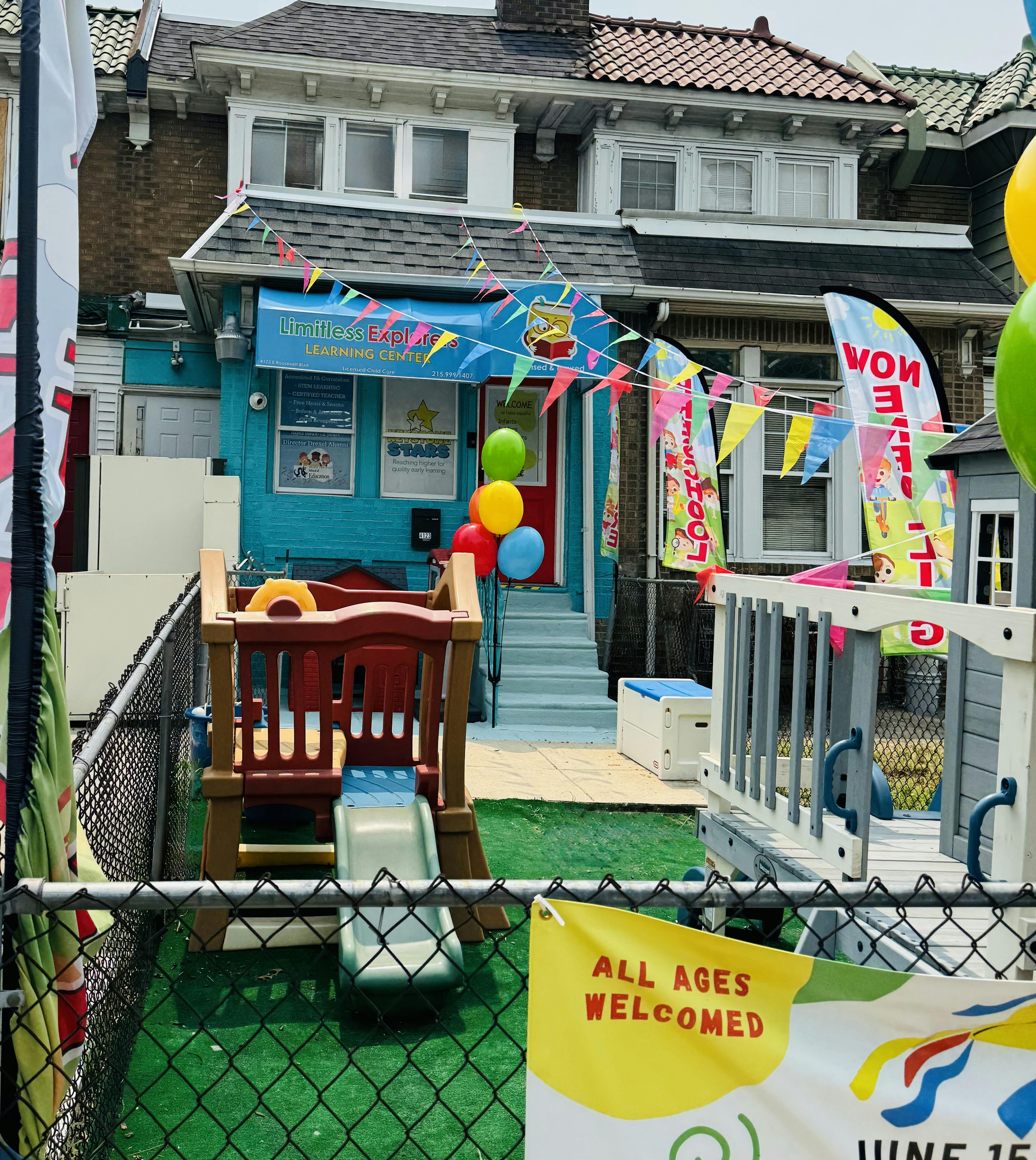 Exterior of Limitless Explorers Learning Center with a play area and flags