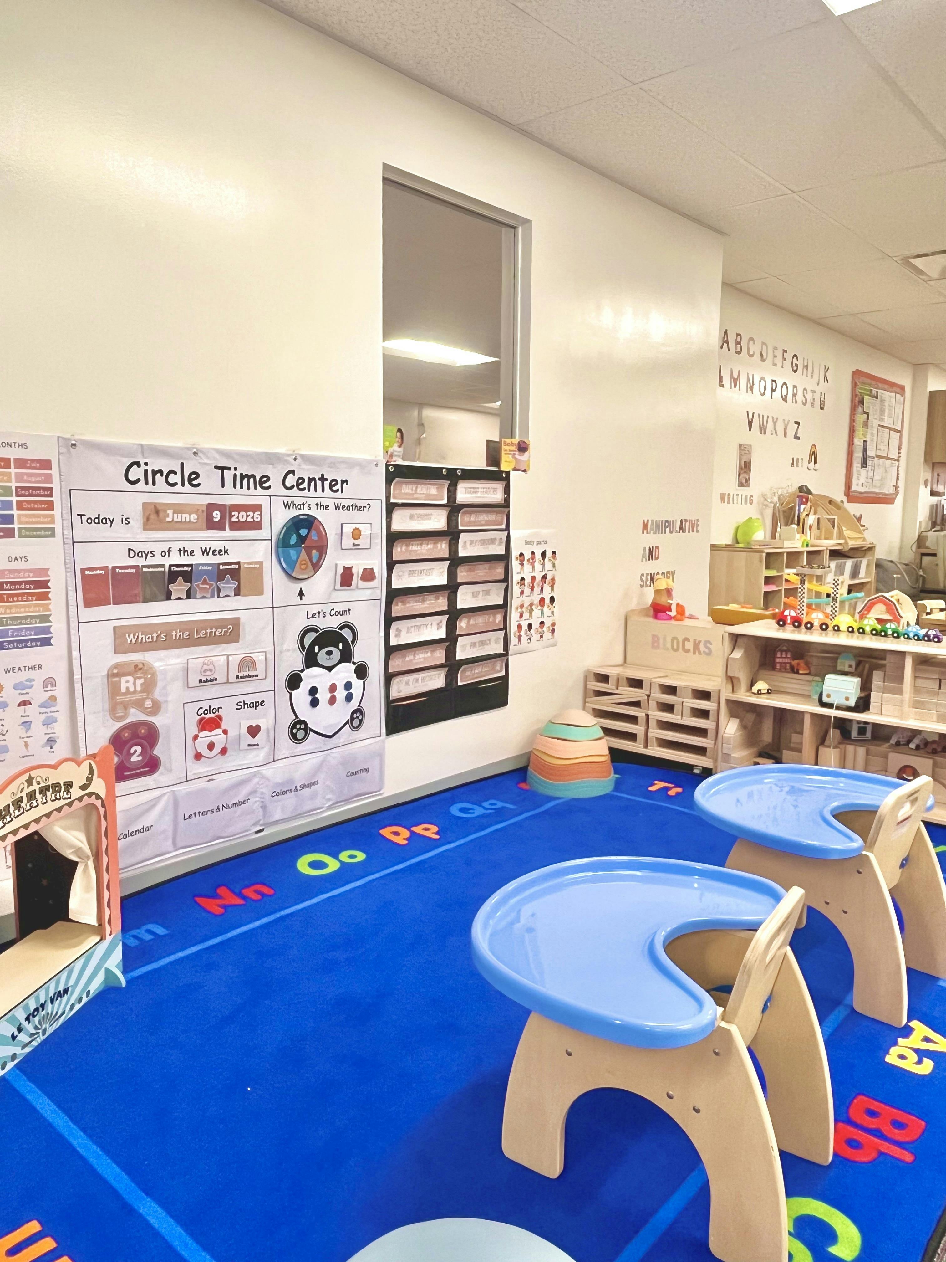Classroom with Circle Time Center chart, play mat, and activity shelves
