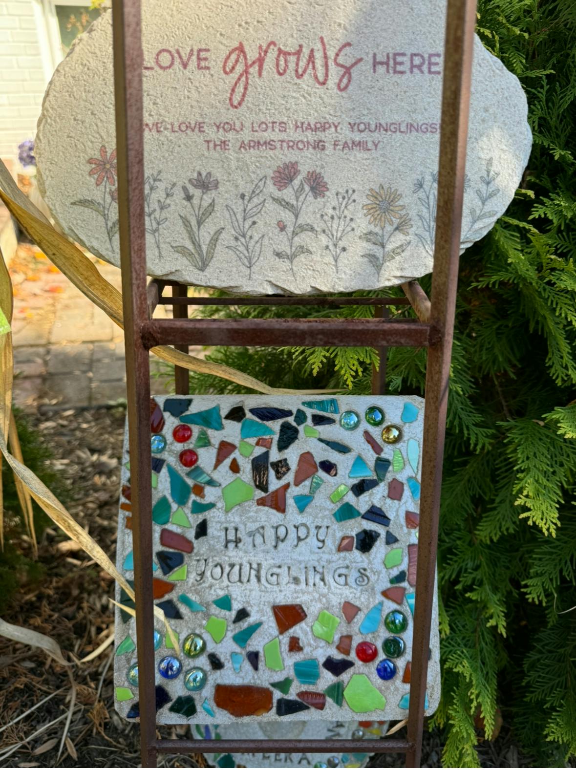 Two decorative garden stones on a metal stand