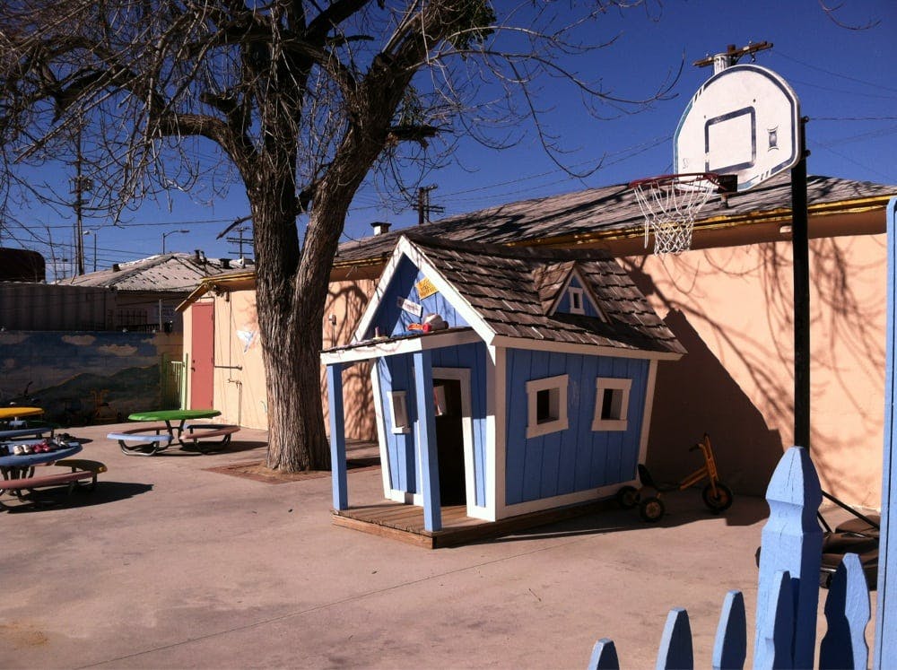 Blue playhouse with a basketball hoop next to it