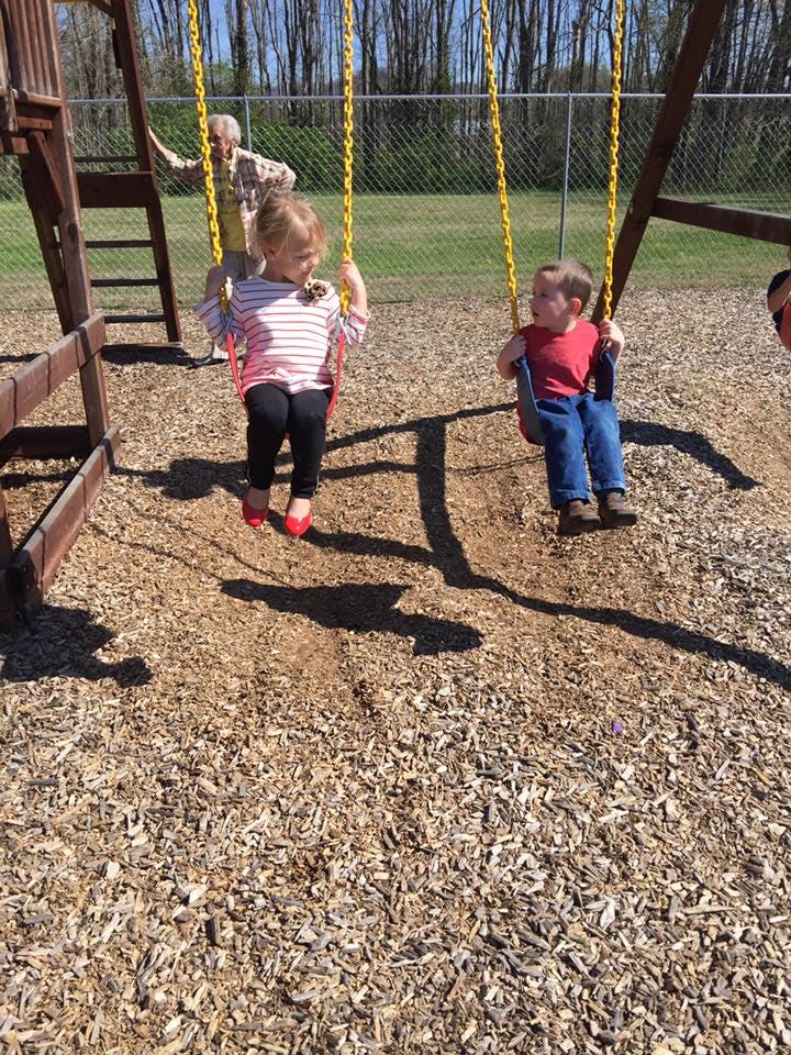 Two children on swings at a playground