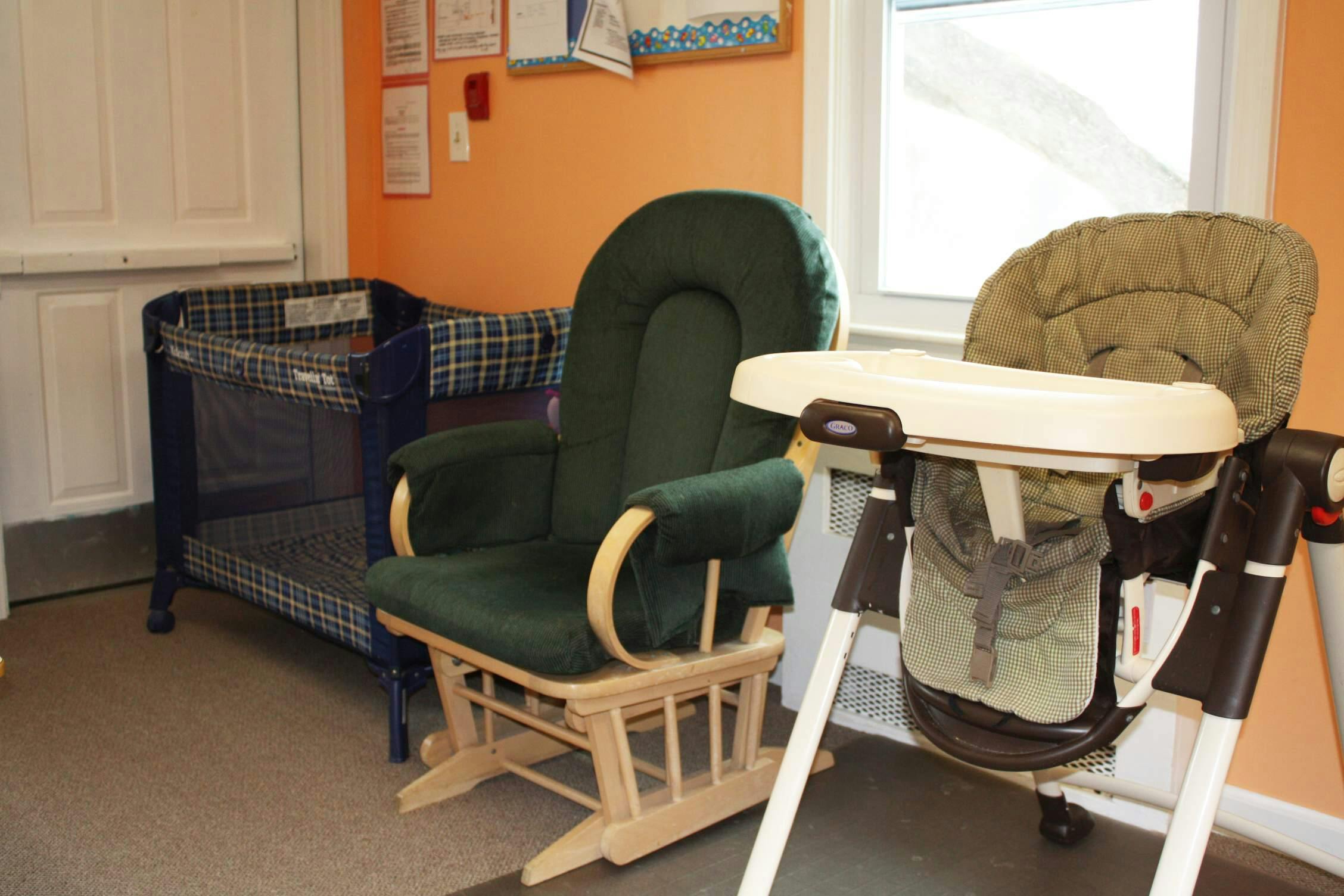 Playpen, rocking chair, and high chair
