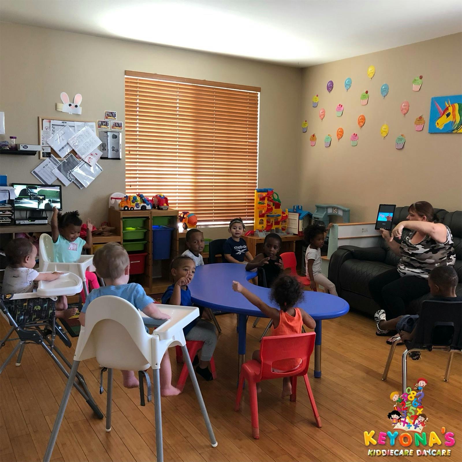Adult and children in a room with tables and chairs