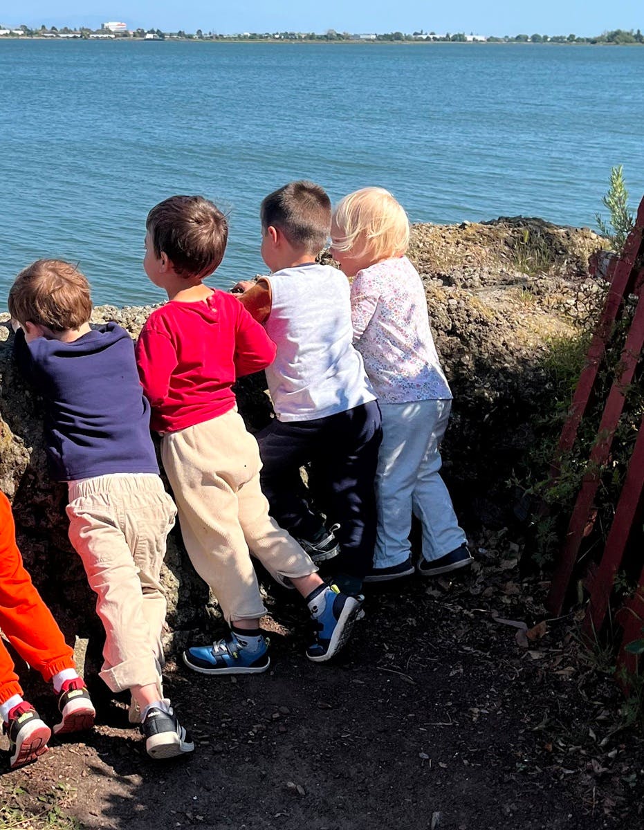Group of children standing by a body of water