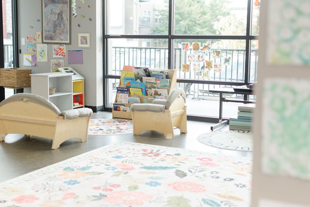 Small chairs and a book display in a child care or learning space