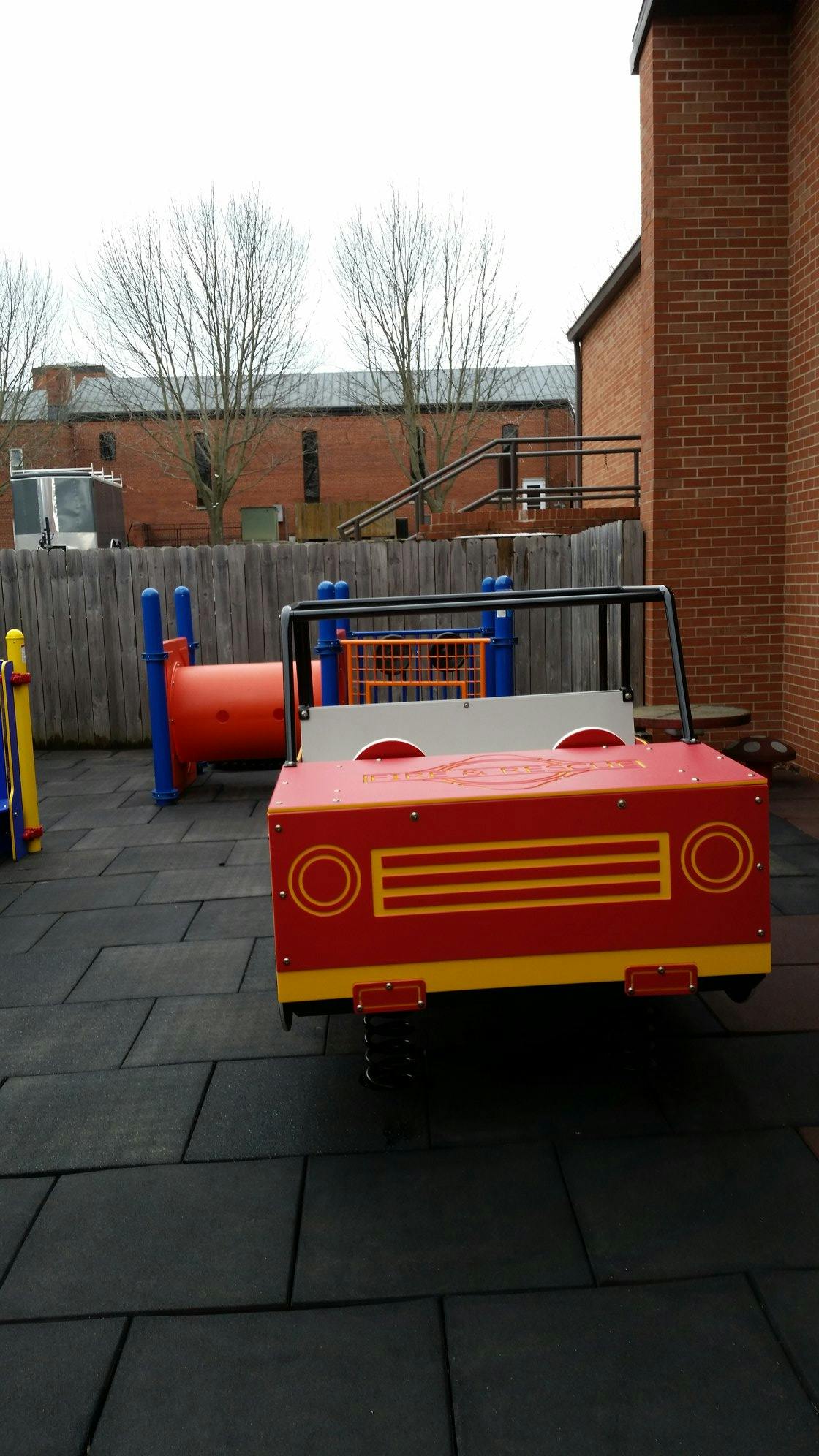 Red and yellow spring rider car on a playground