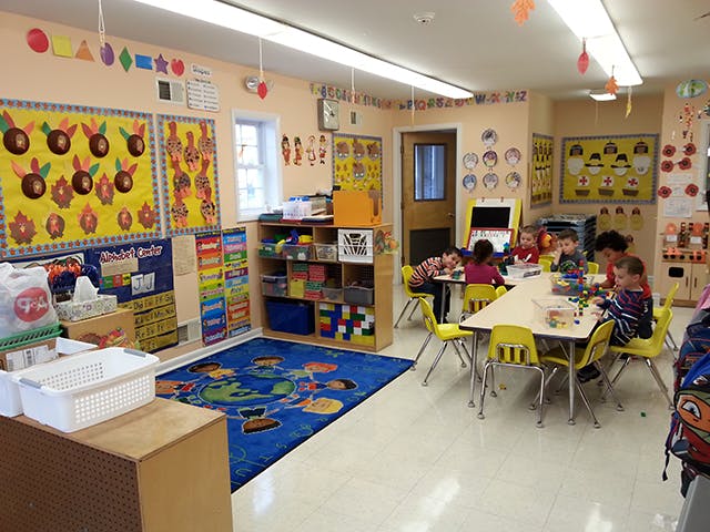 Children sitting at tables in a classroom