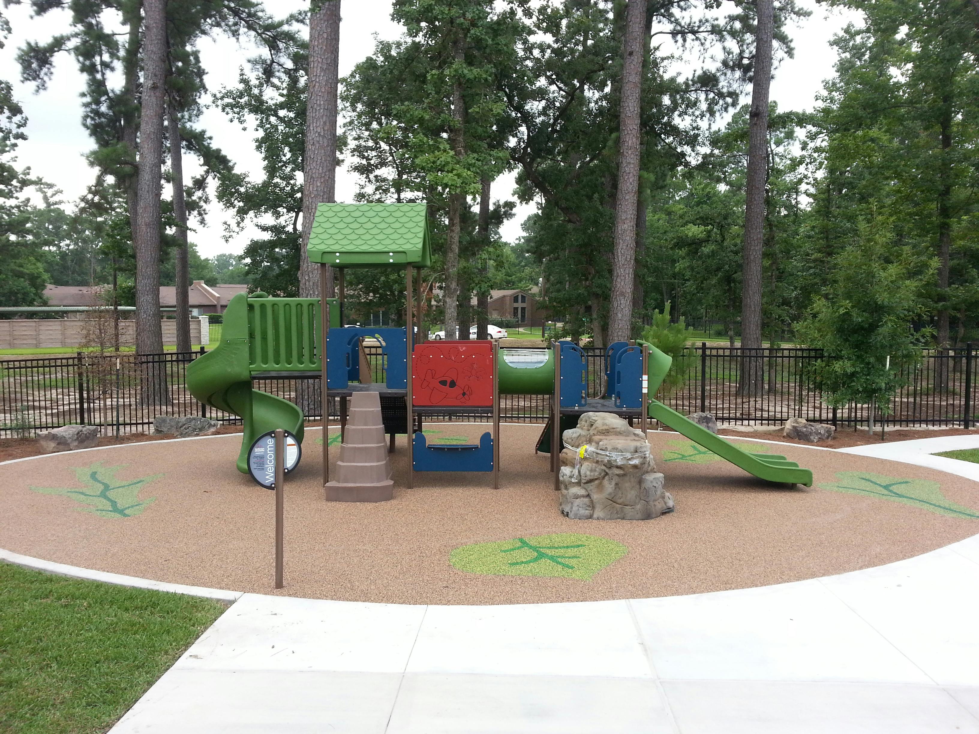 Playground with slides, climbing structures, and a rock wall