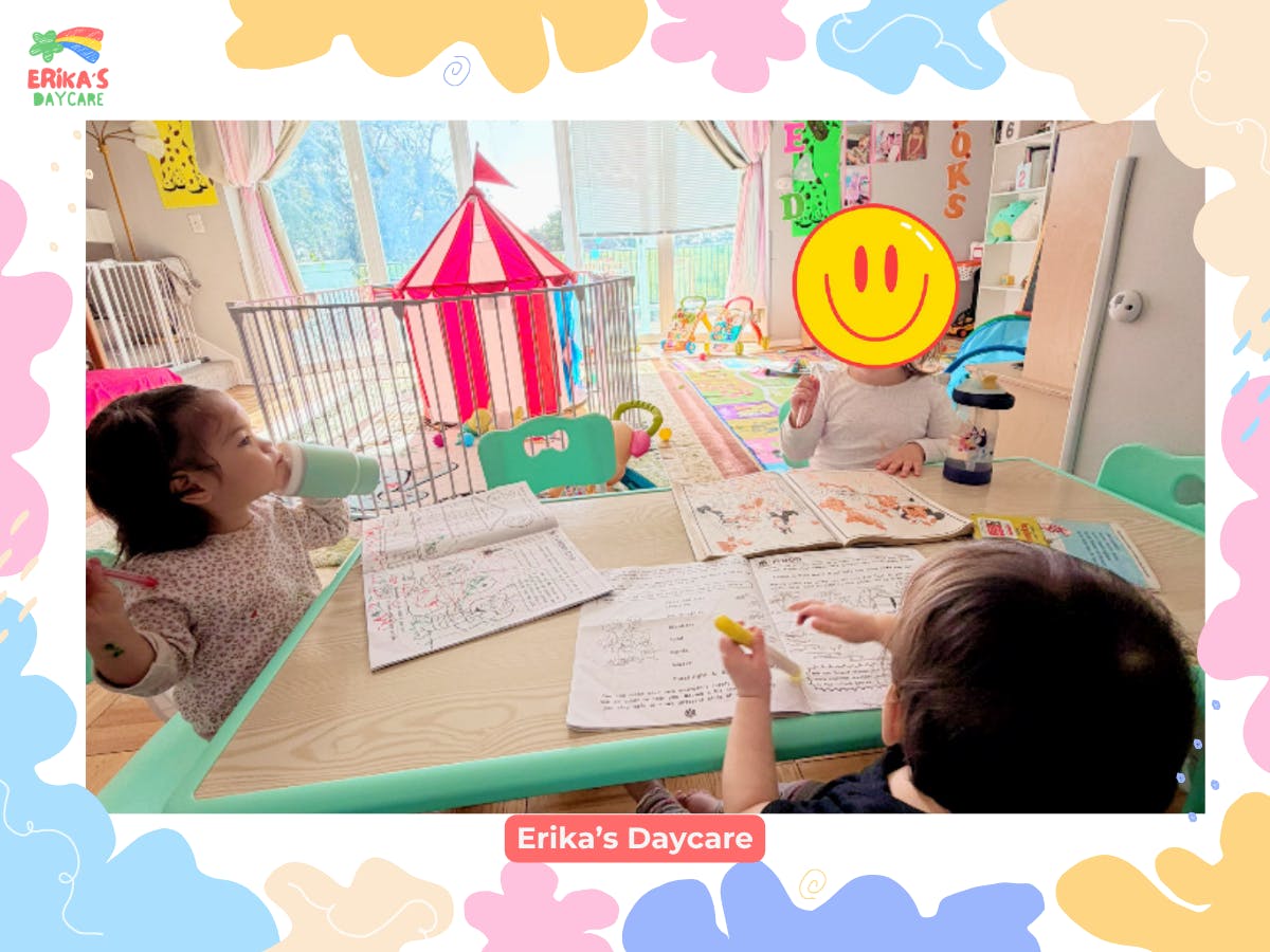 Three children working in books at a table in a daycare setting