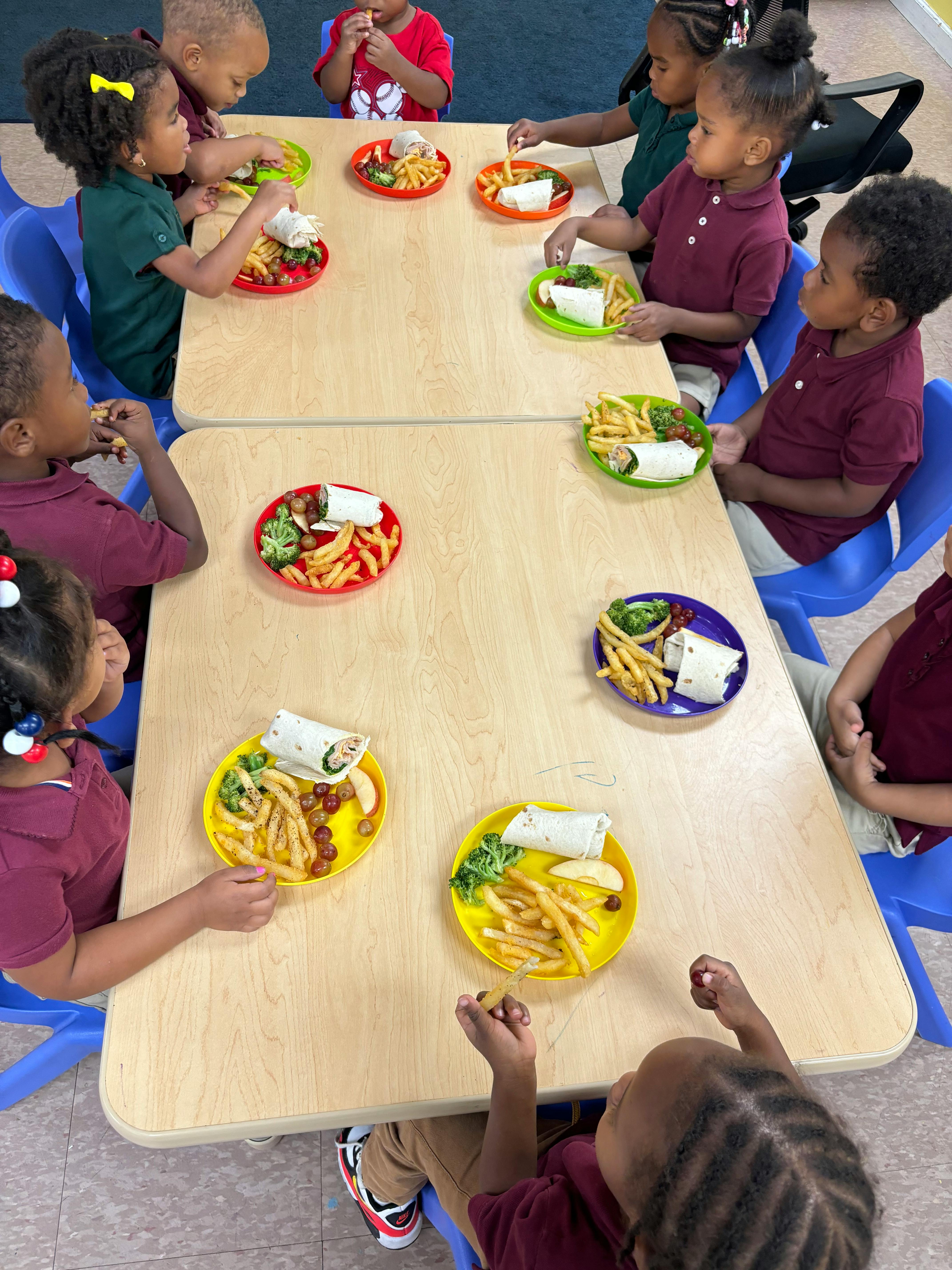 Children eating meals at tables
