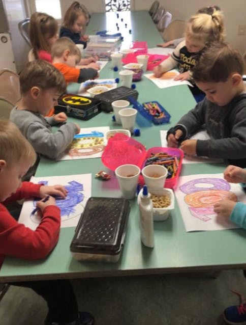 Children coloring and crafting at a table