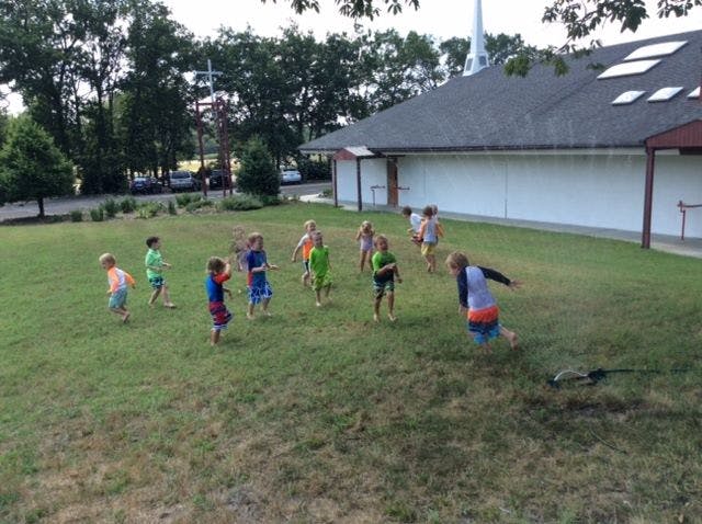 Children playing on a grassy field