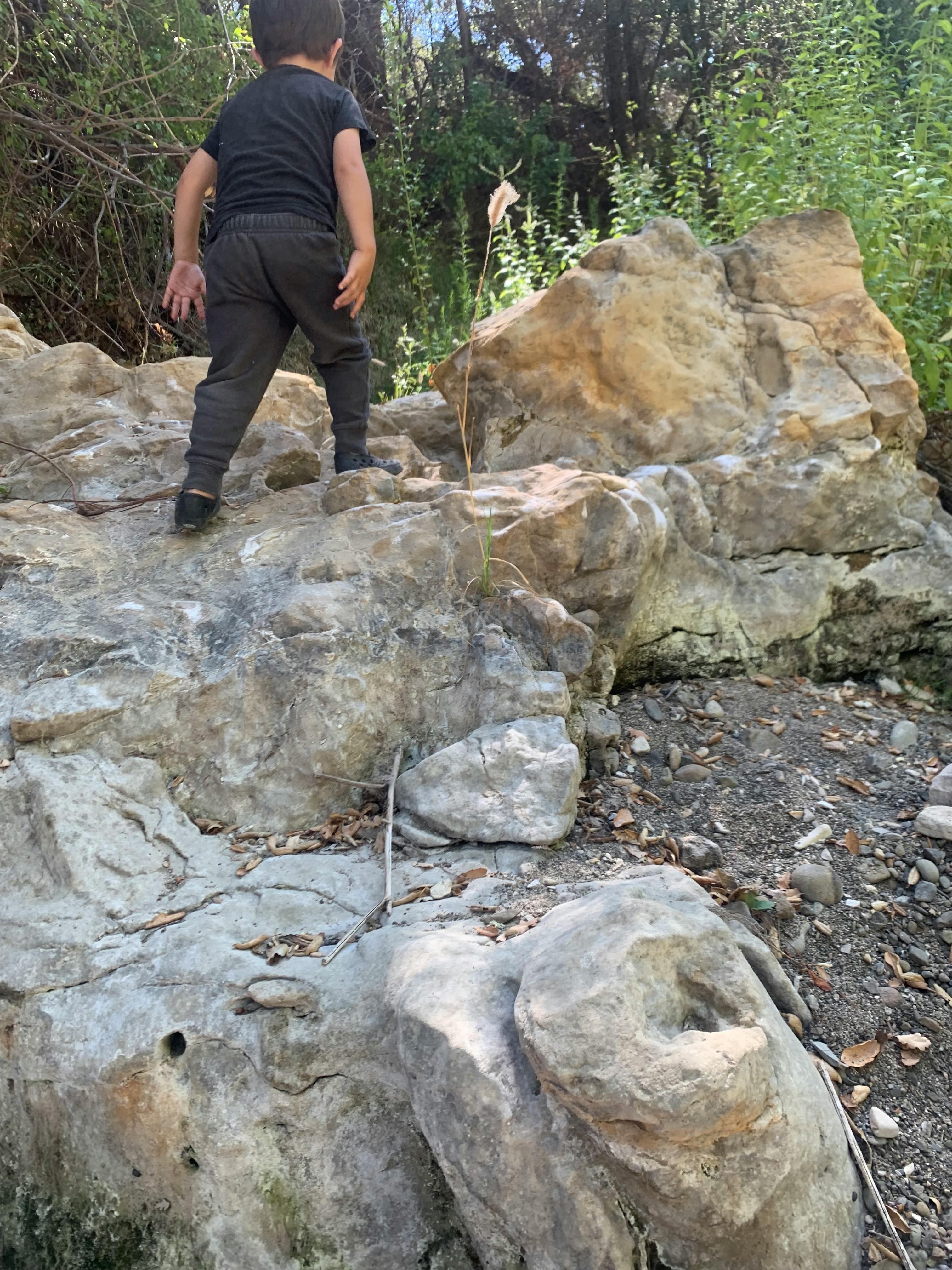 Child climbing on large rocks