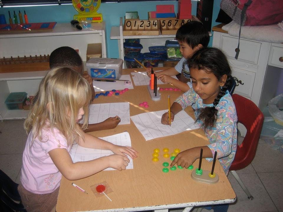 Children working at a table in a classroom