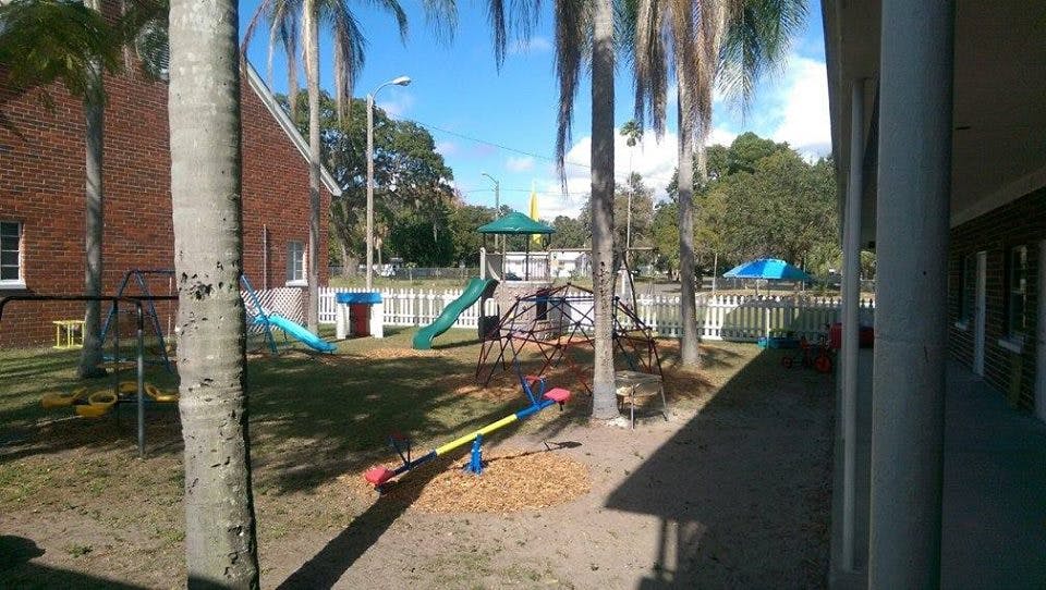Outdoor playground with slides, swings, and a seesaw