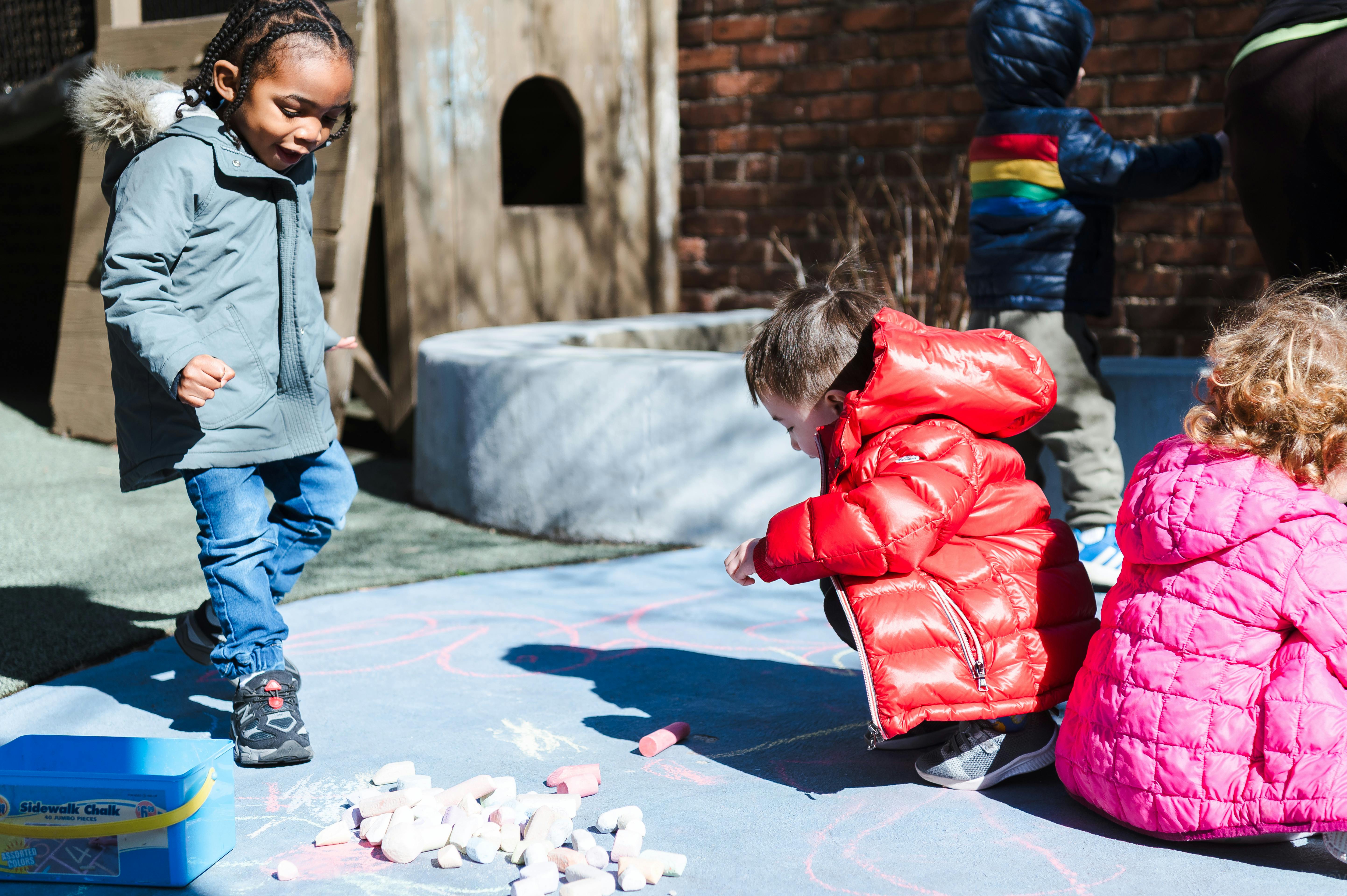 Children playing with chalk outdoors