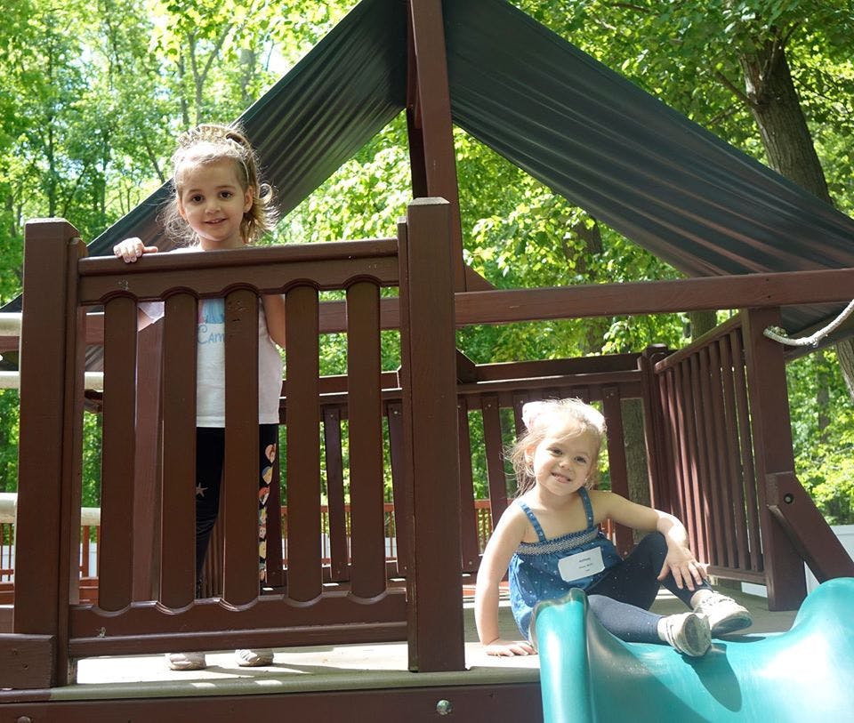 Two children on a playground structure