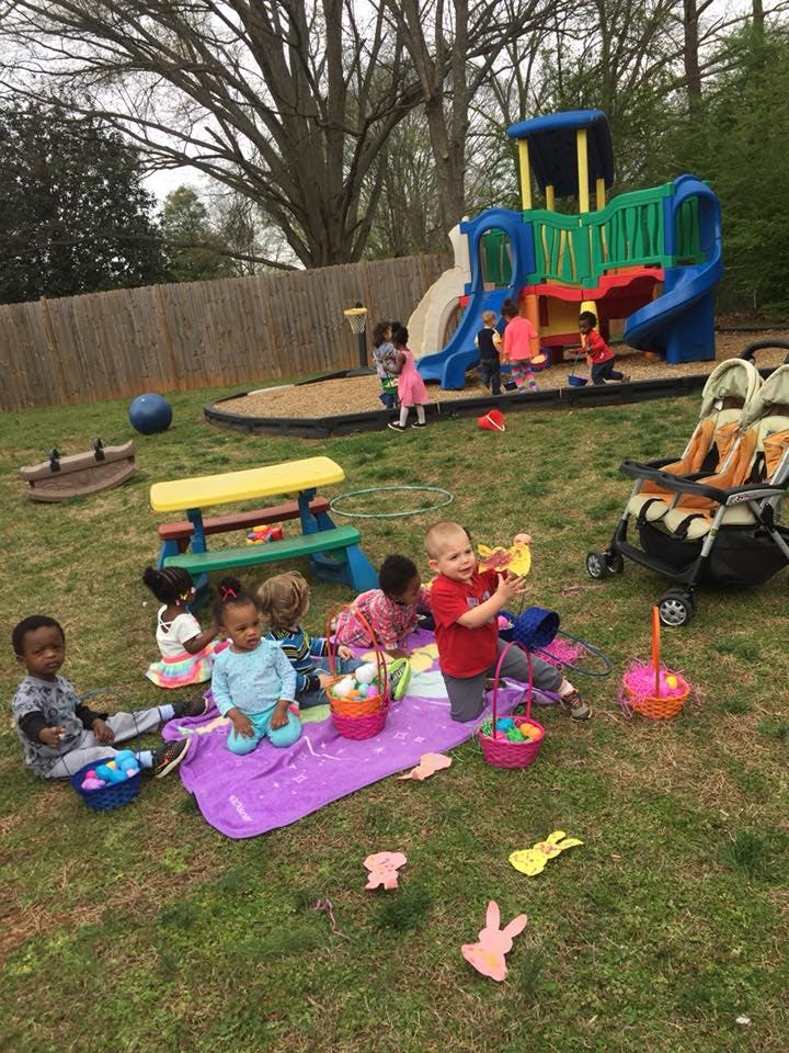 Children playing outdoors with Easter baskets and a playground in the background