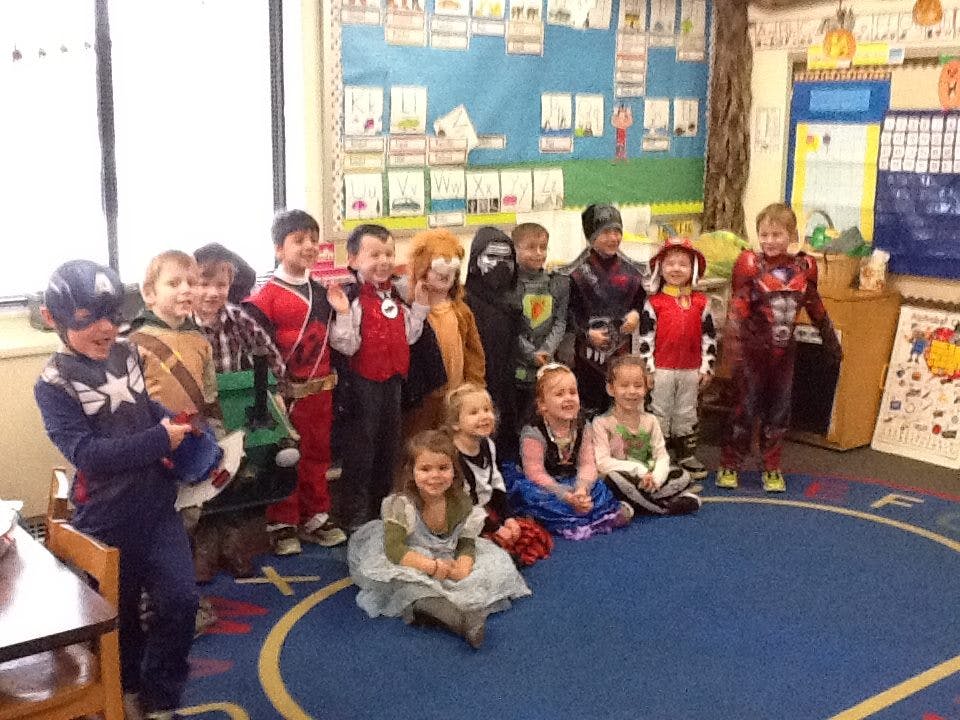 Group of children in costumes in a classroom