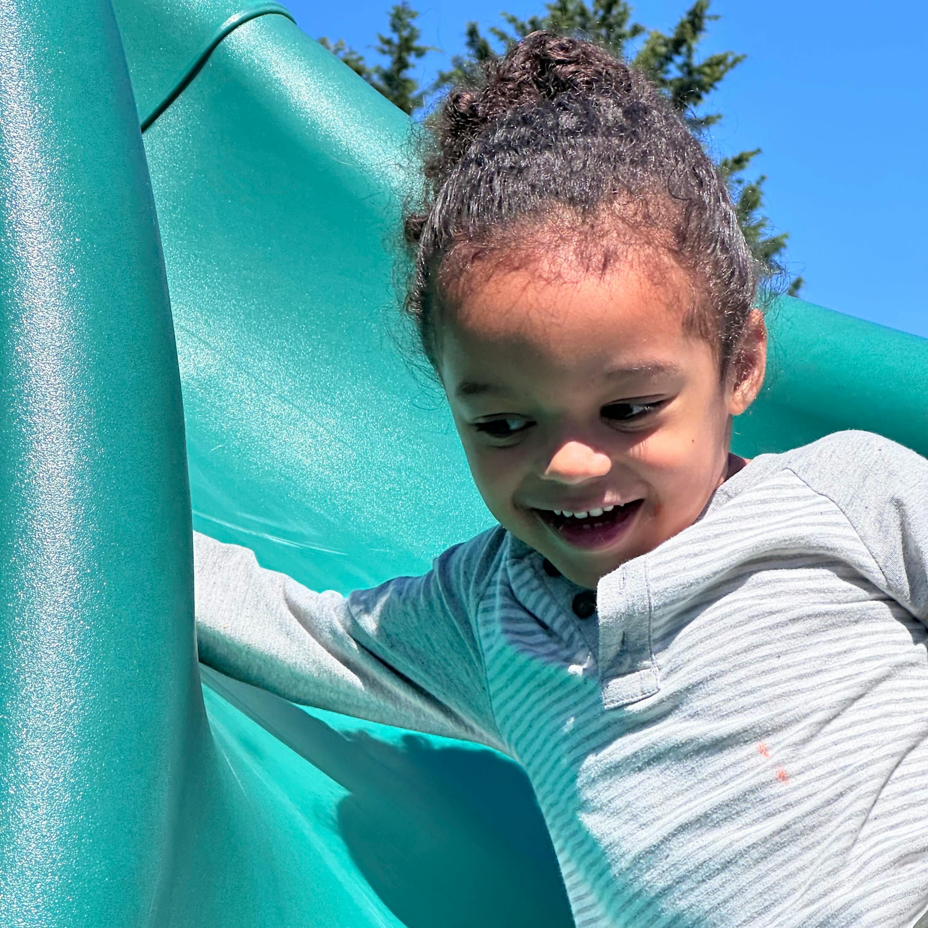 Child on a green slide