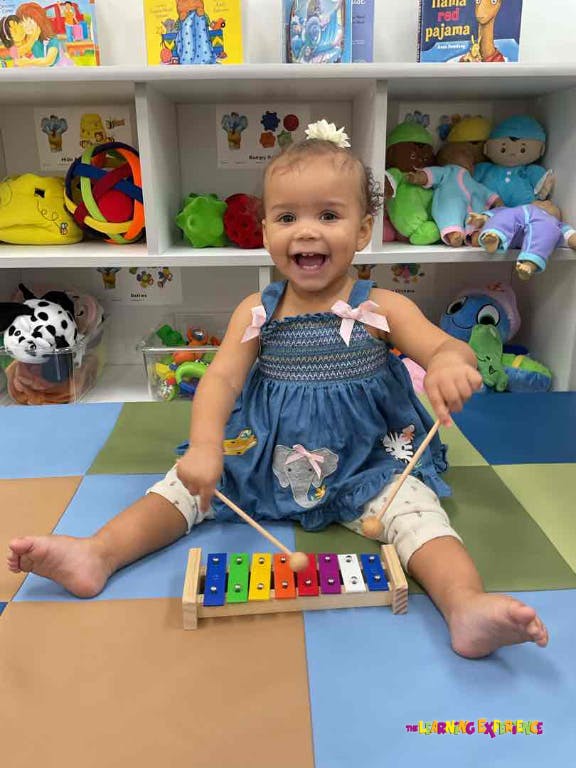 Child playing a colorful xylophone