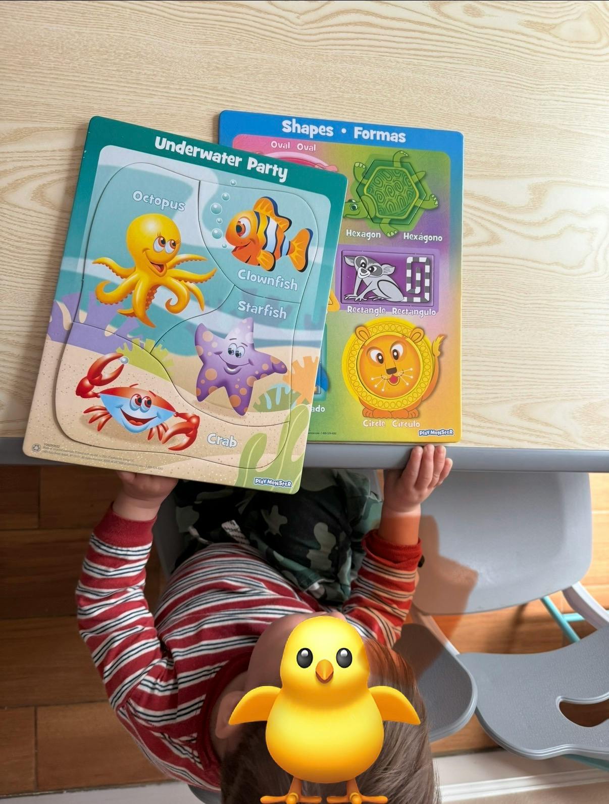 Child looking at a "Underwater Party" puzzle and a "Shapes" puzzle