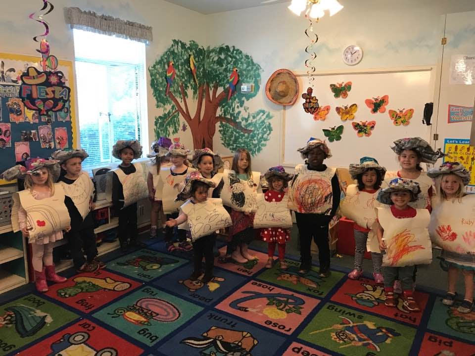 Group of children in costumes in a classroom