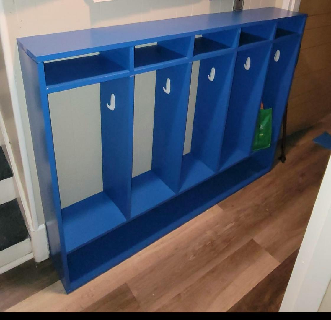 Blue storage unit with cubbies and hooks