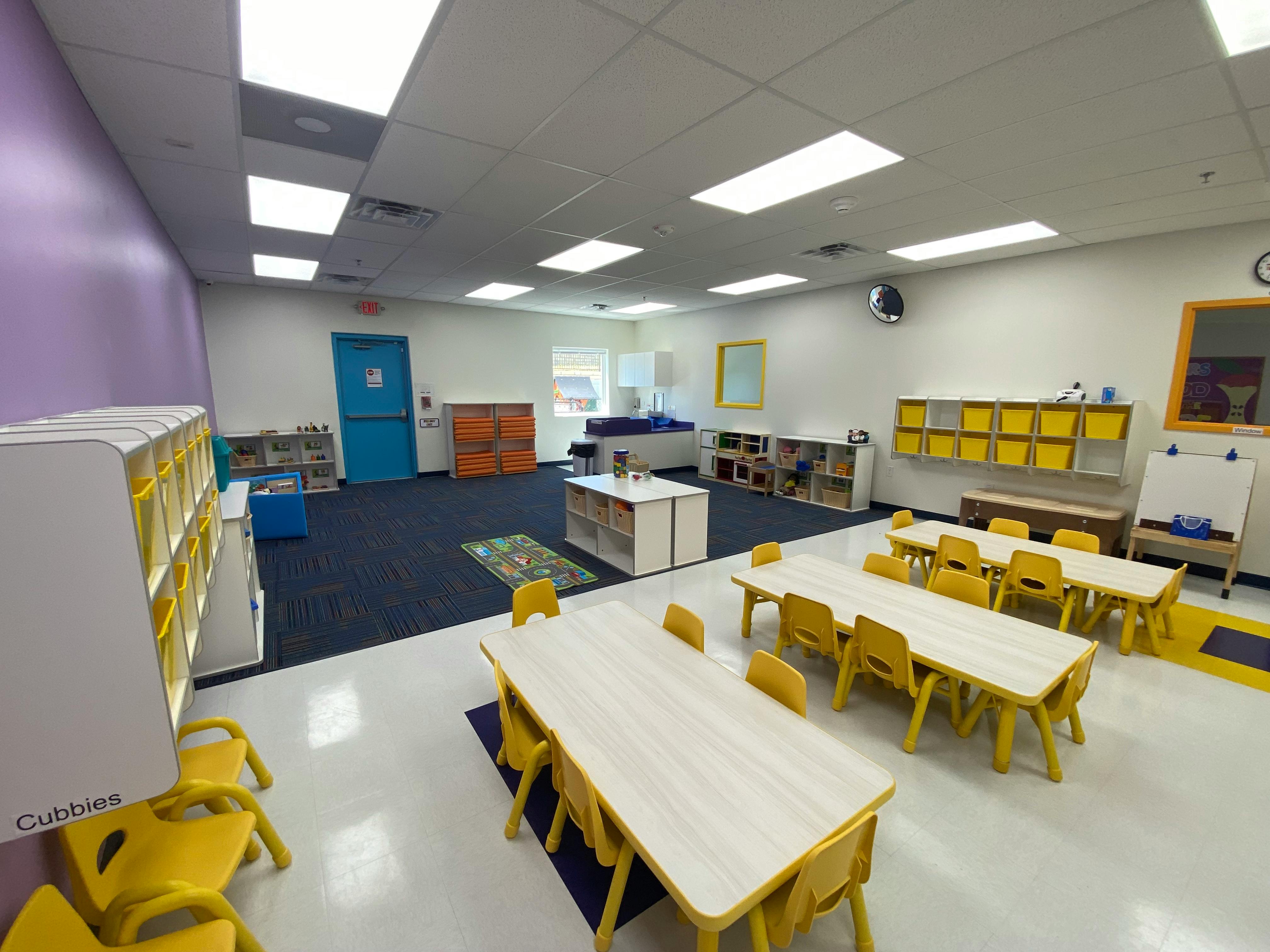 Empty classroom with small tables and chairs