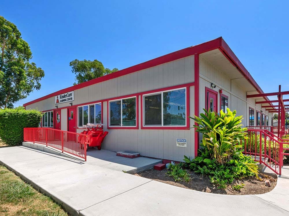 KinderCare Learning Center building exterior with red trim and railings