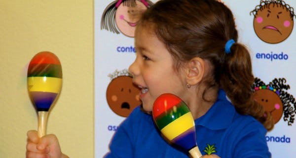 Child playing two maracas