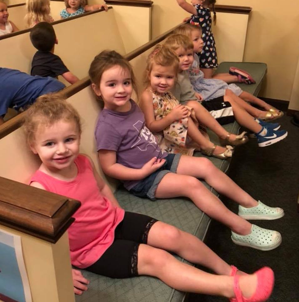 Children sitting on benches