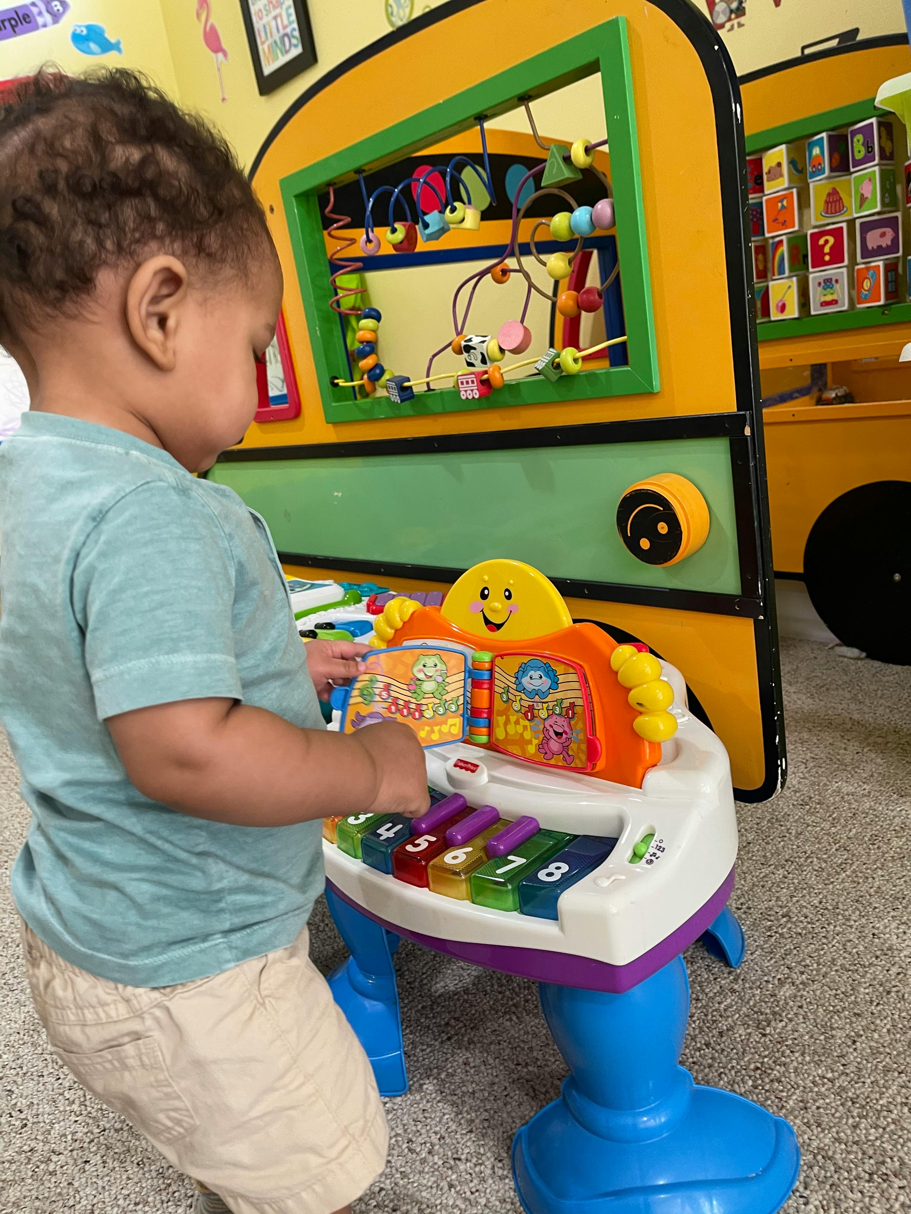 Child playing with a toy piano