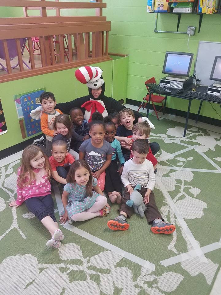 Person in Cat in the Hat costume with a group of children