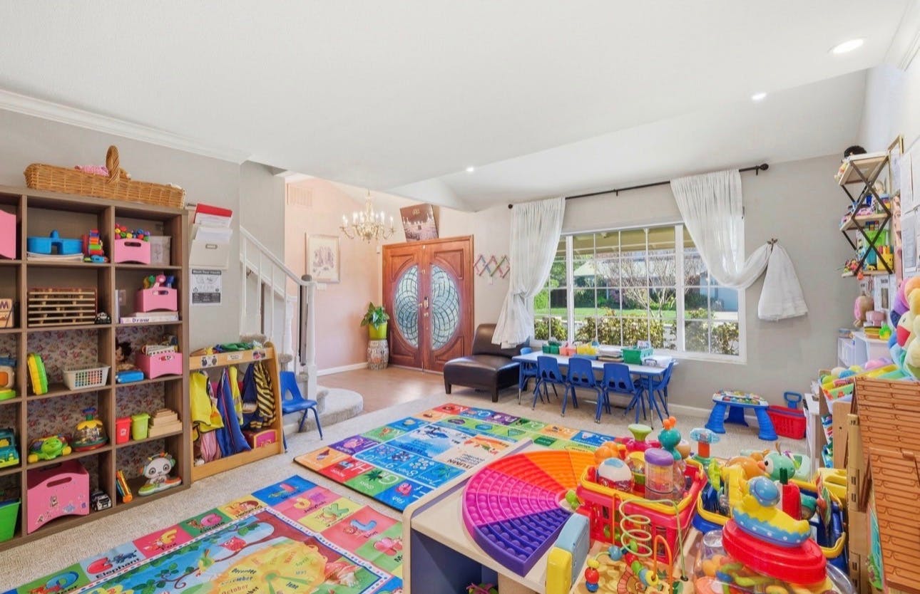 Spacious playroom filled with educational toys and colorful floor mats