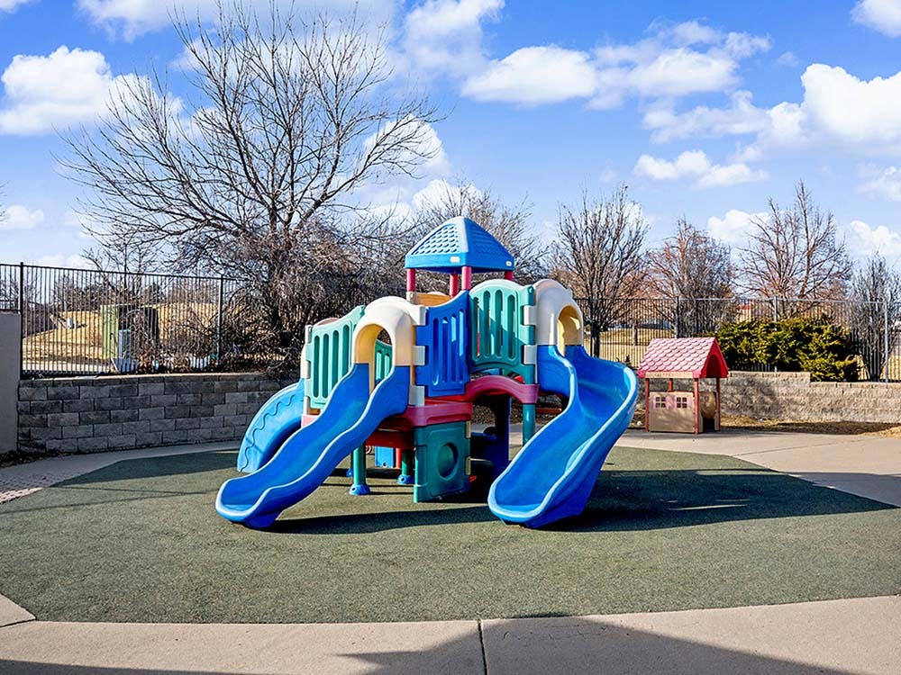 Colorful playground structure with blue slides on a sunny day