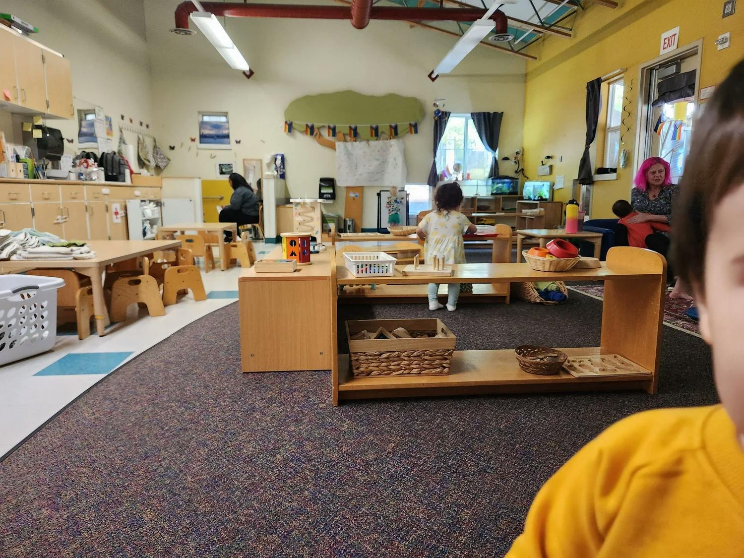 Classroom with people and children playing with toys