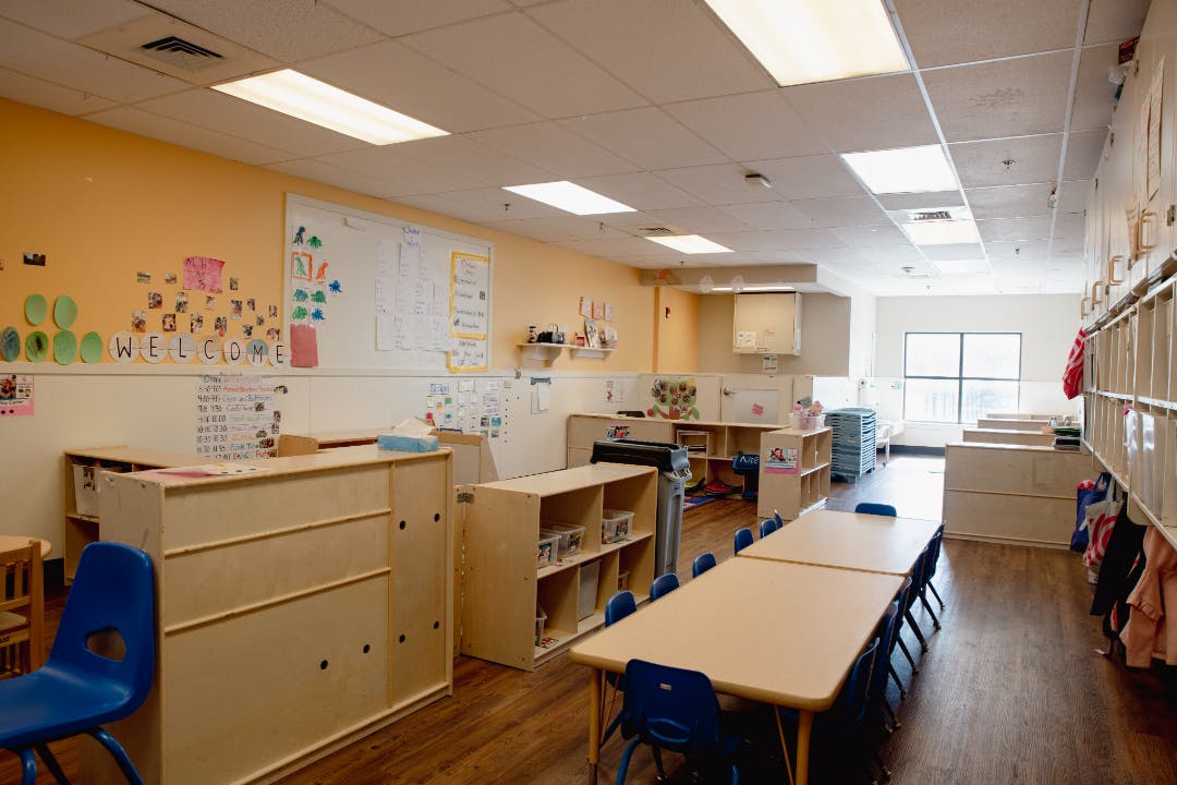 empty classroom with tables, chairs, and storage
