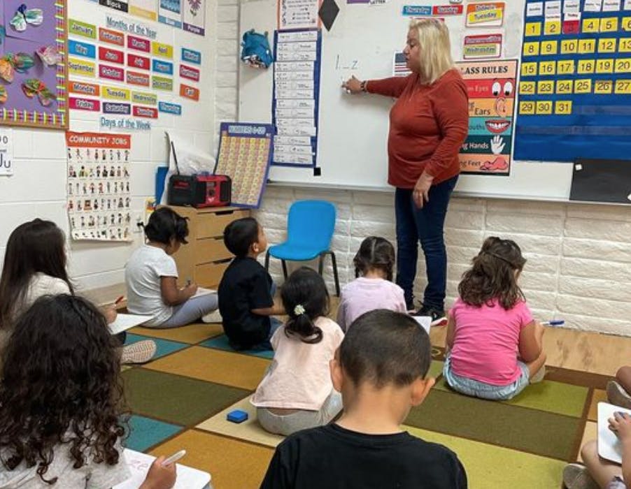 Person teaching children in a classroom