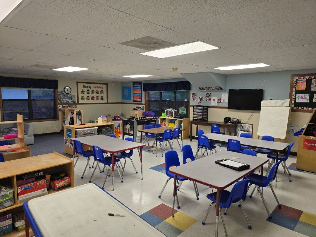Empty classroom with small tables and chairs