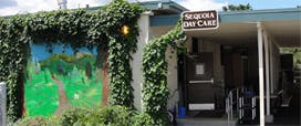 Building entrance with "Sequoia Day Care" sign and ivy-covered walls