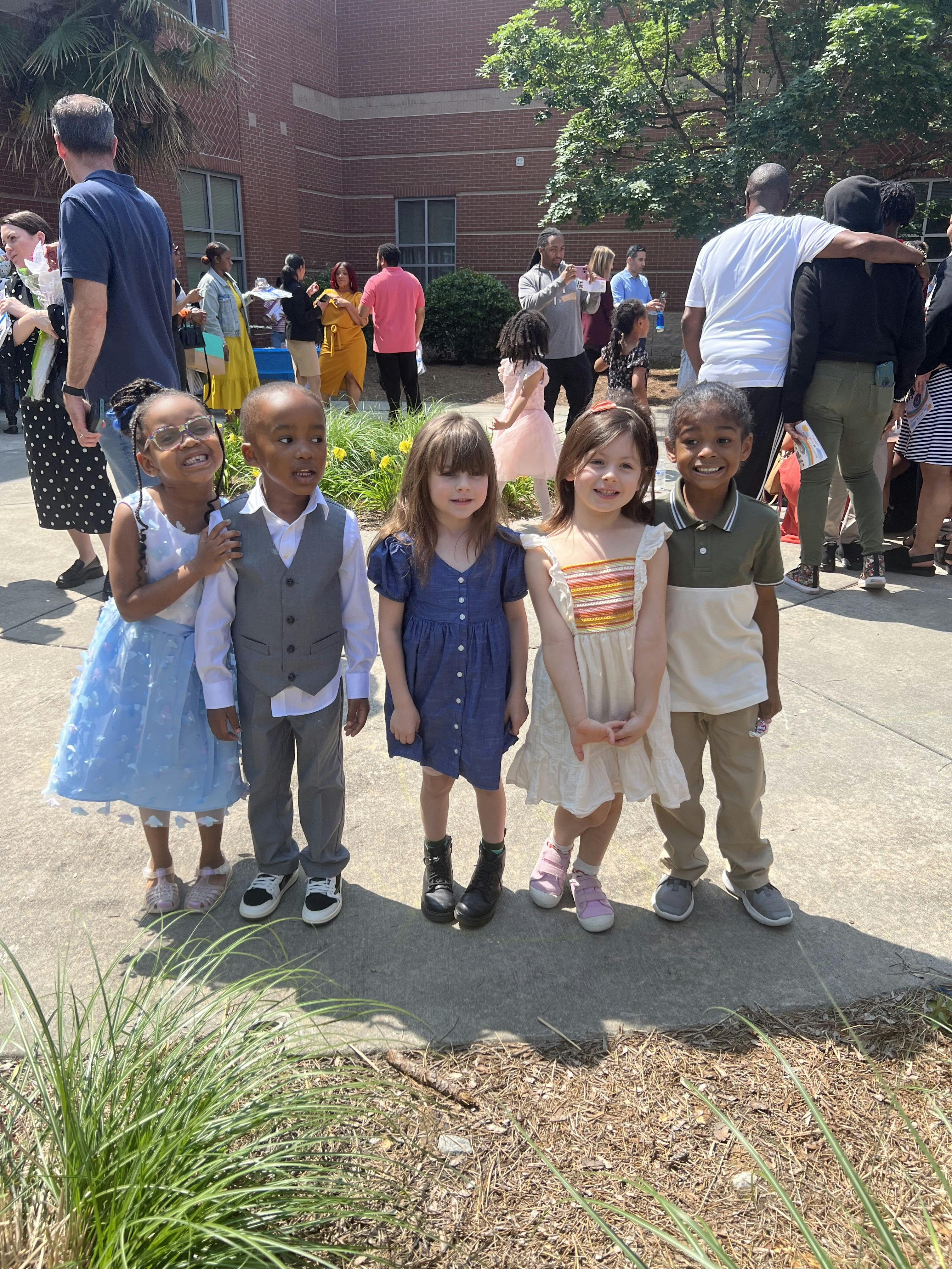 Five children standing together outdoors