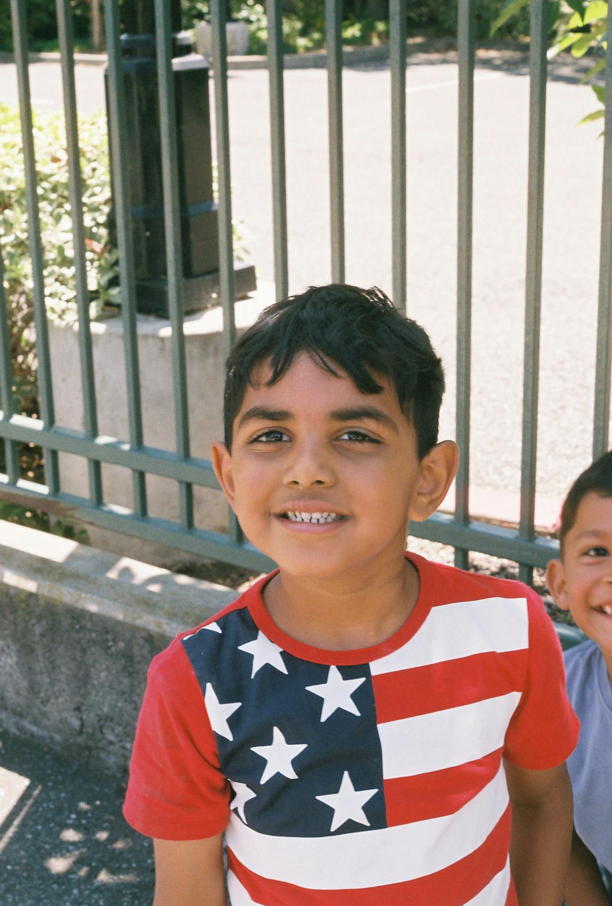 Child in a red, white, and blue shirt with stars and stripes