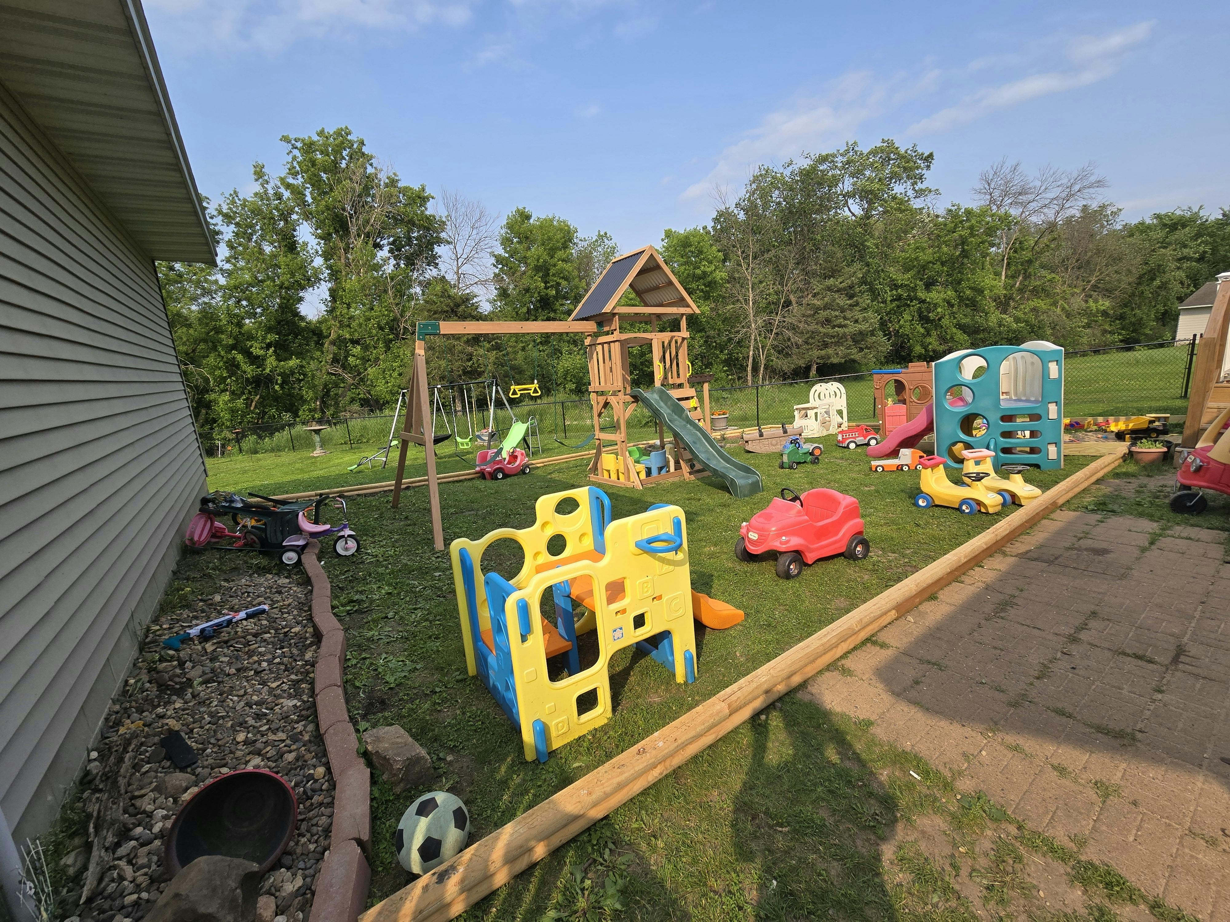 Outdoor playground with swings, slides, and various colorful play structures