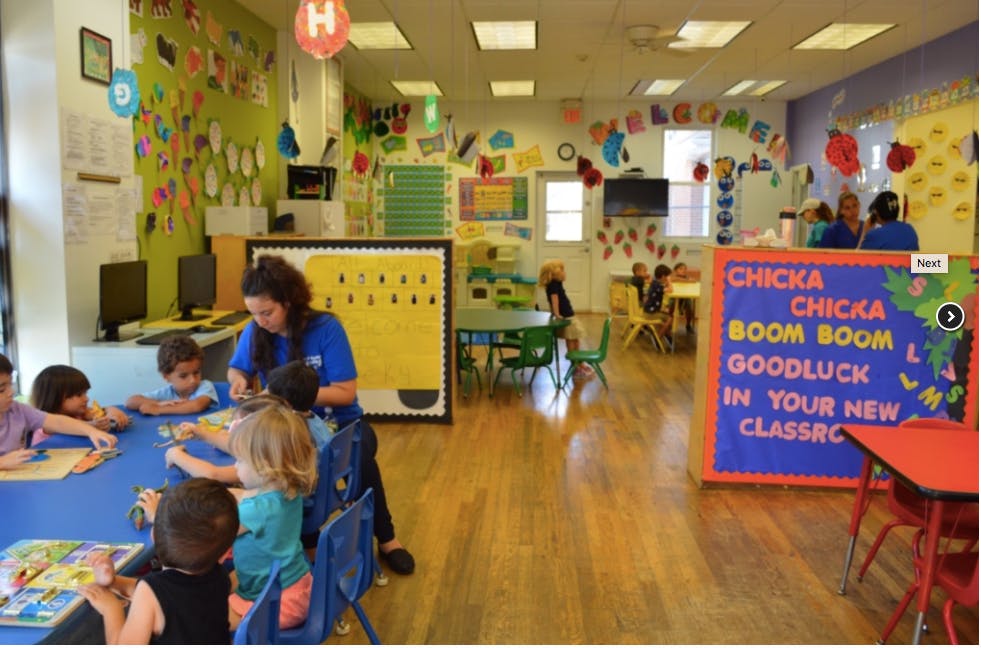 Adult and children at a table in a classroom