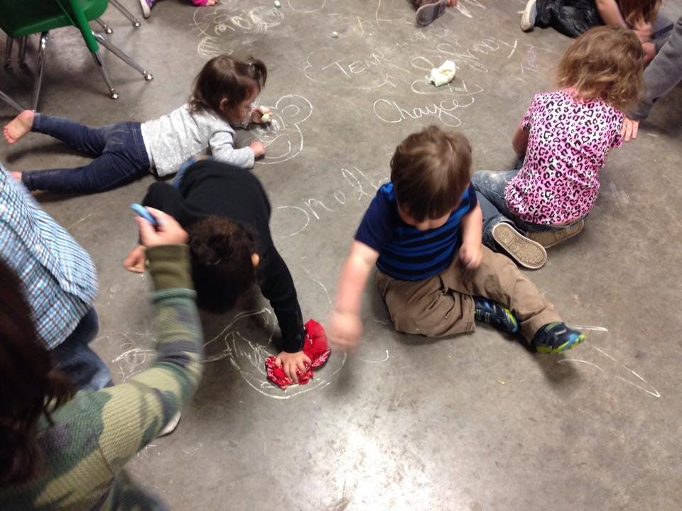 Children drawing with chalk on a floor